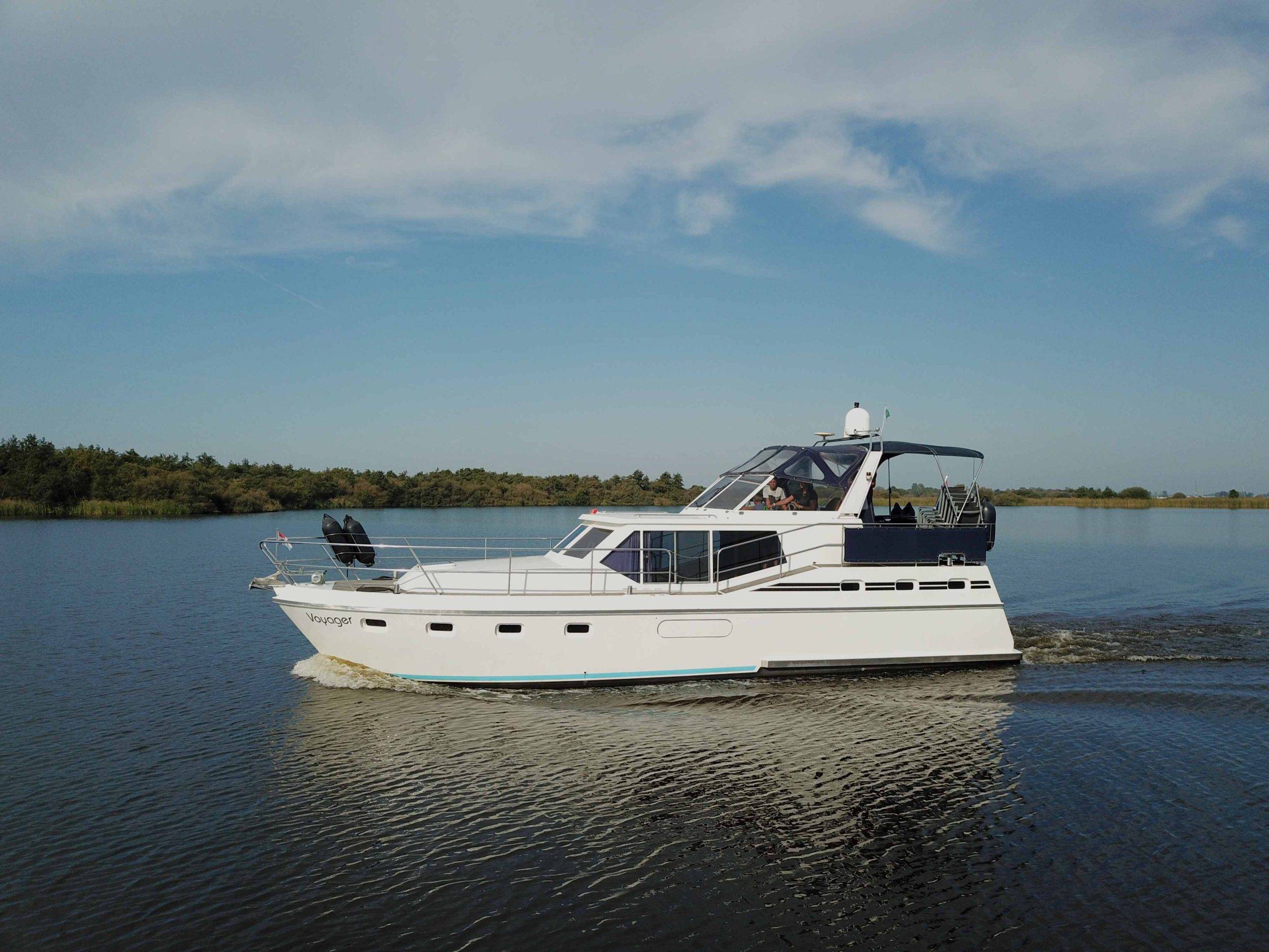 Luxury motor yacht Voyager passing by in Friesland